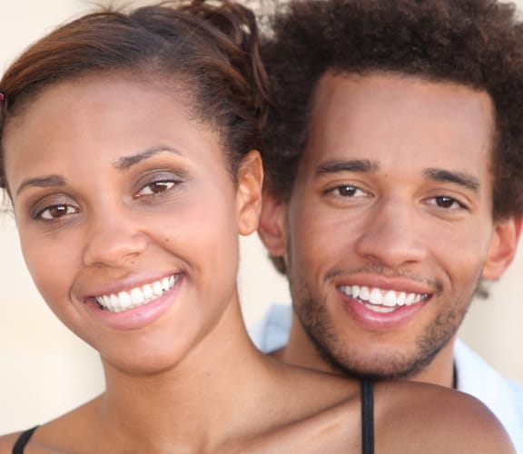 Middle aged couple standing next to each other smiling