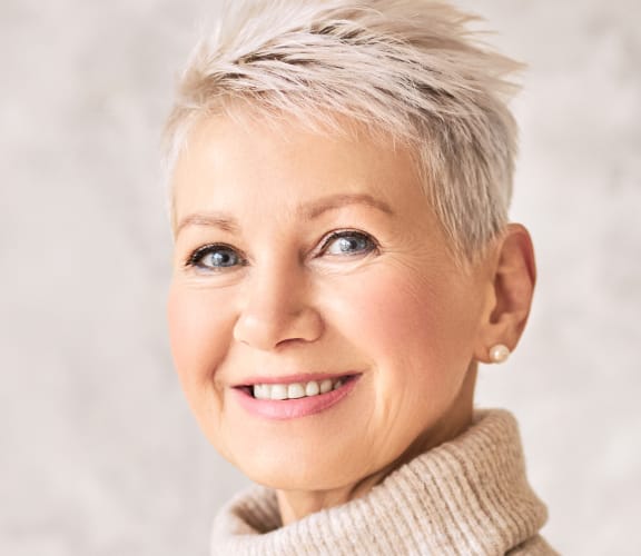 Mature woman with a sweater on smiling